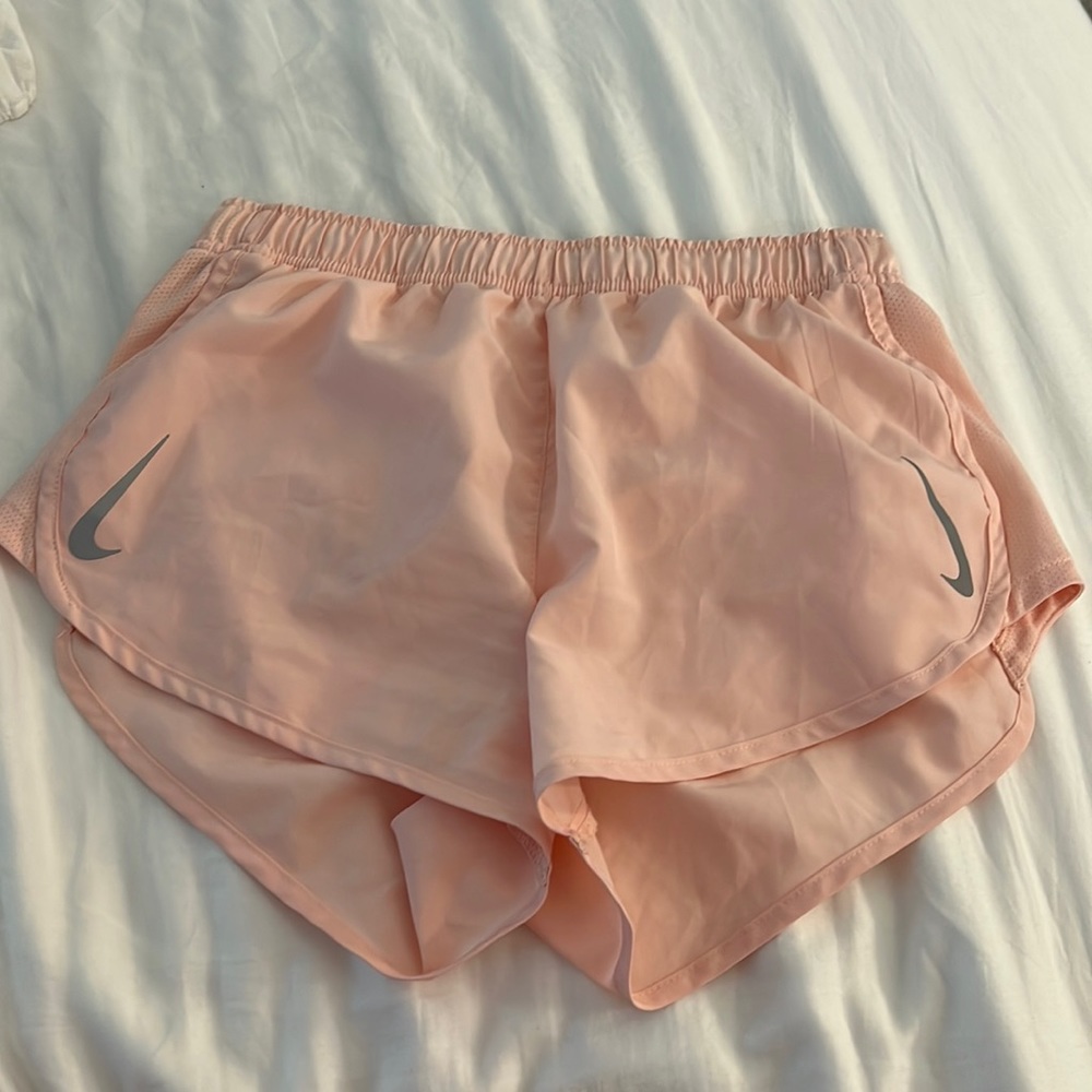 Pink Nike running shorts.
